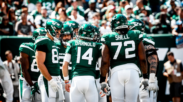The Gotham Green-clad Jets offense huddles up.